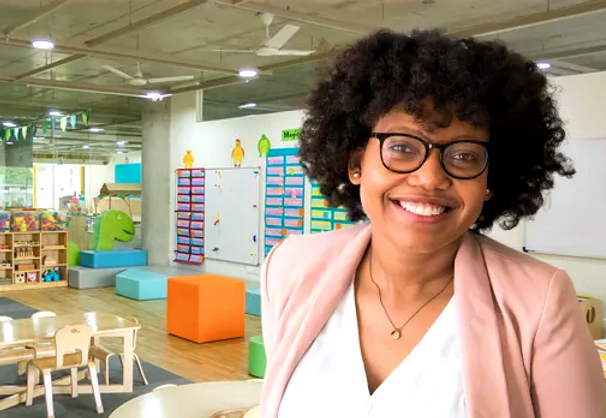 smiling teacher in empty classroom